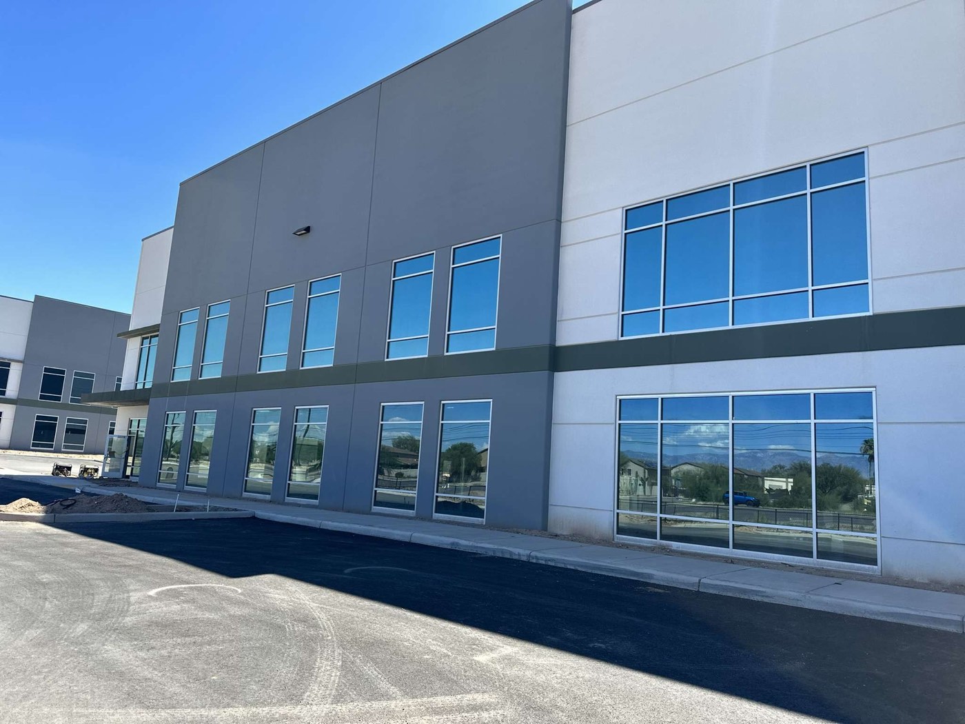 New two-story office building in Tucson with reflective window film on every window